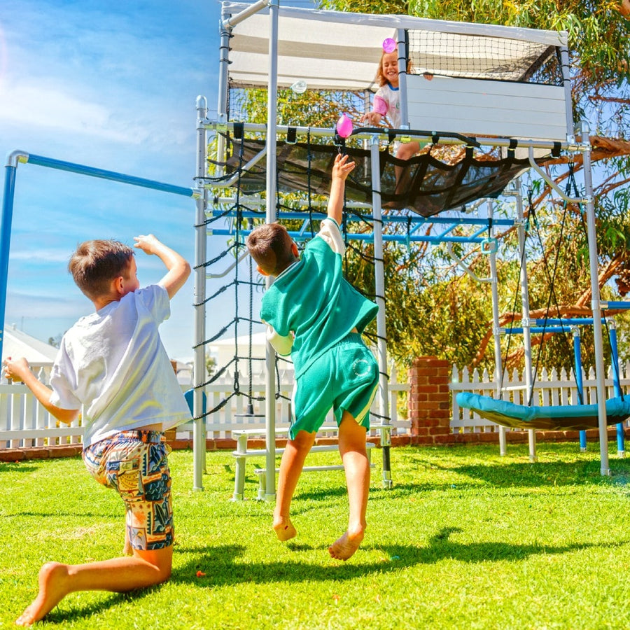 Children playing around a Growplay cubby house and playhouse in New Zealand