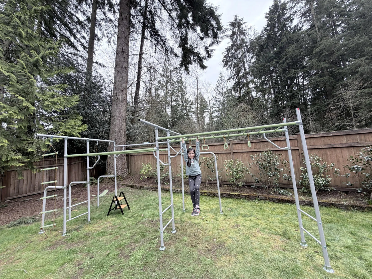 Extension Monkey Bars in use on a Growplay frame in a family garden