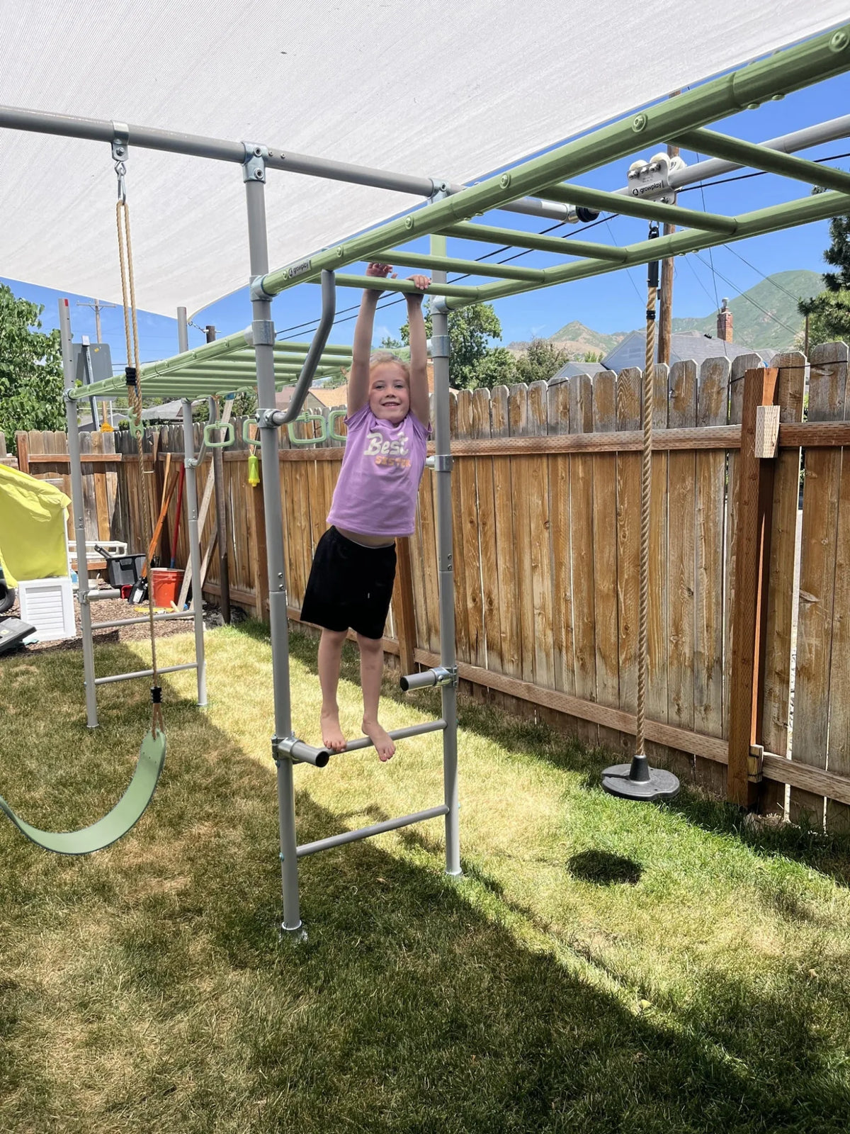 Extension Monkey Bars in use on a Growplay frame in a family garden
