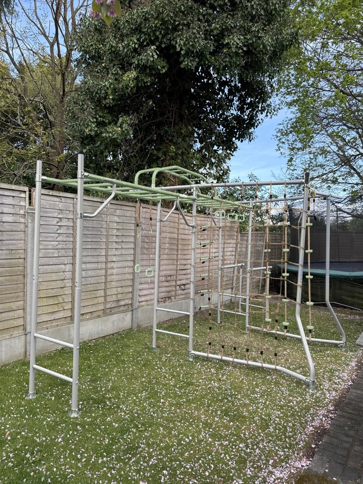 Extension Monkey Bars in use on a Growplay frame in a family garden