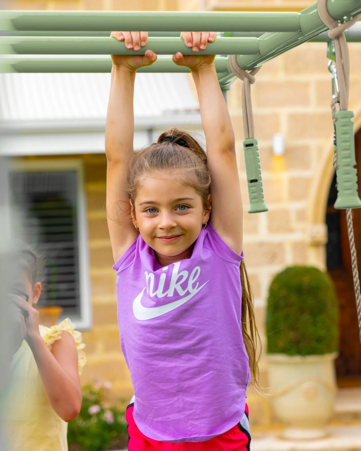 Ninja Sticks in use on a Growplay frame in a family garden