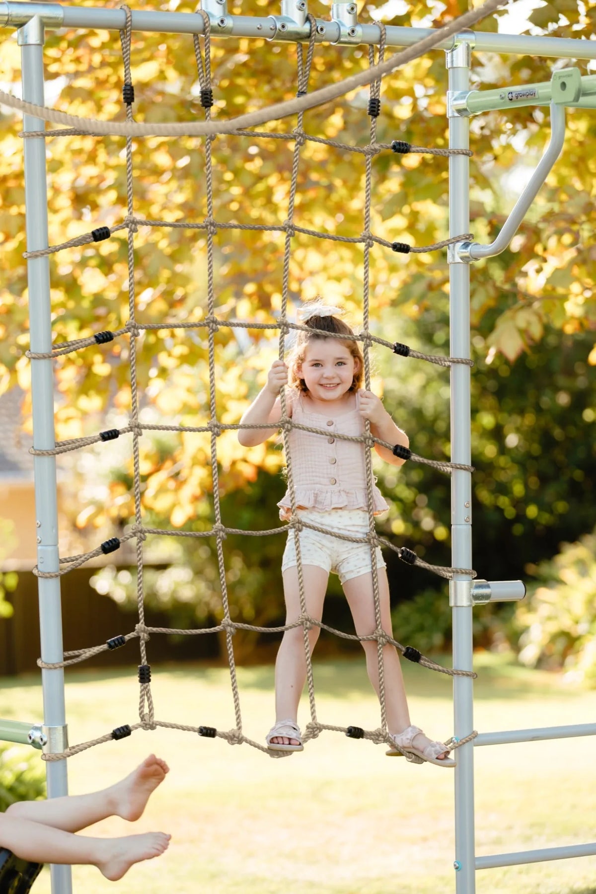 Cargo Net + Pole in use on a Growplay frame in a family garden