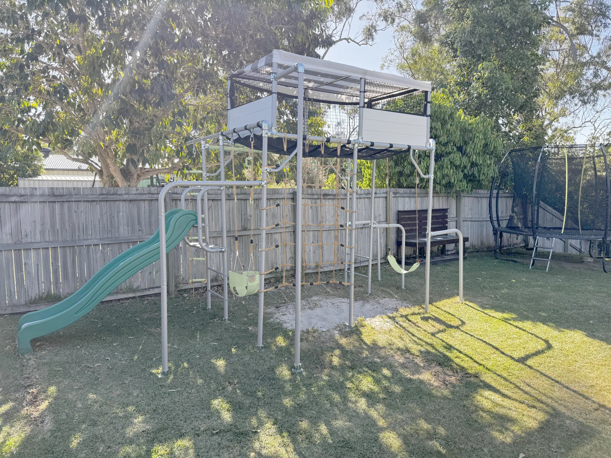 LARGE PLAYHOUSE in green in a family garden